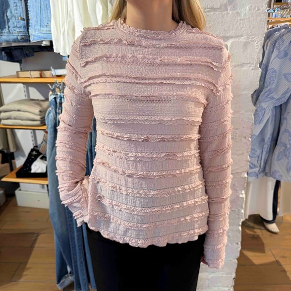 Stretchig topp med volangdetaljer – lång ärm