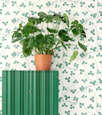 Retrotapet med gröna klöverblad från Josef Frank som matchas fint med vacker möbel och gröna växter.